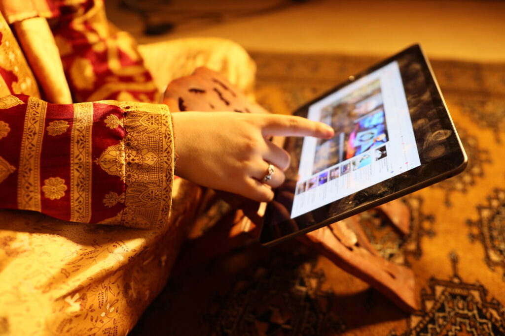 A woman touching the screen of an iPad